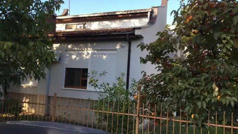 Exterior view of a two-story house with a fenced yard and fruit trees. - image 4