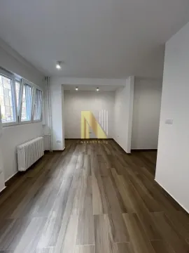 Empty room with wooden flooring and windows. - image 2
