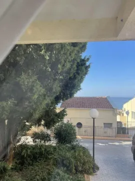 View from the window showing greenery and surrounding buildings. - image 2