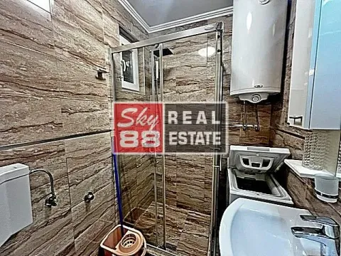 Bathroom with a shower cabin, washbasin, and water heater. - image 16