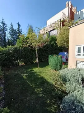 Landscaped backyard with lawn and greenery. - image 3