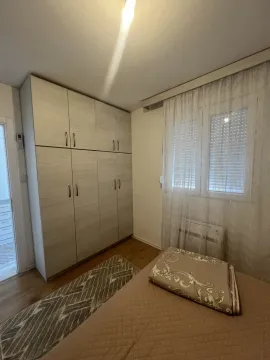 A bedroom with a wardrobe and window. - image 4