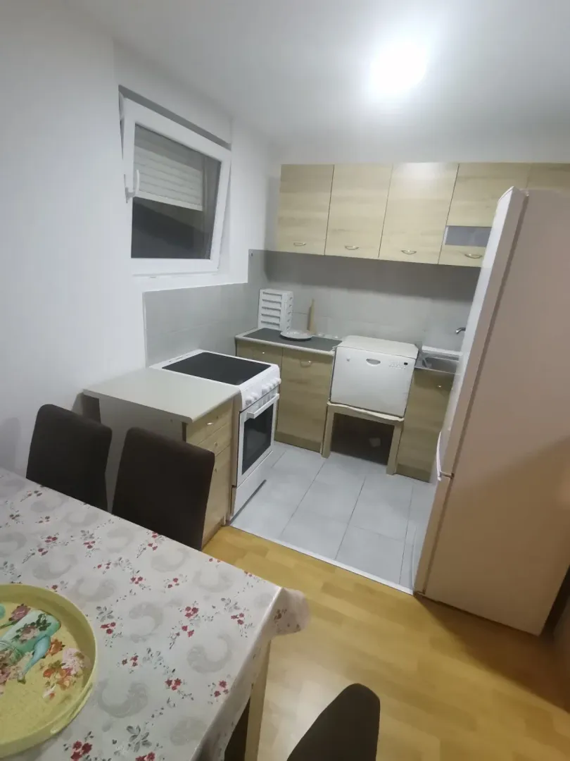 Simple kitchen with a dining table and basic appliances.