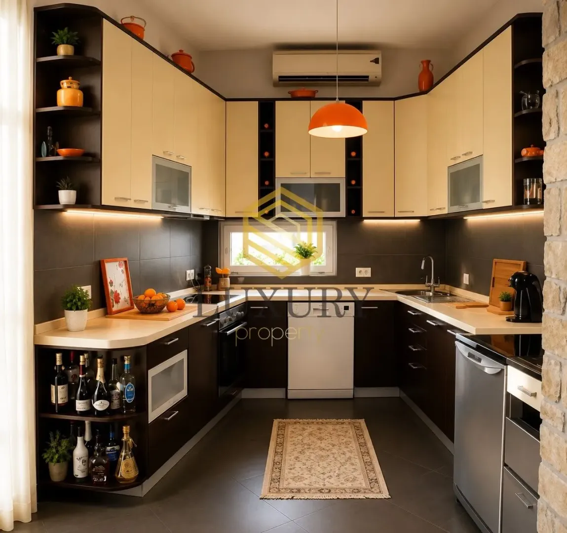 Modern kitchen with dark cabinetry, built-in appliances, and decorative details.