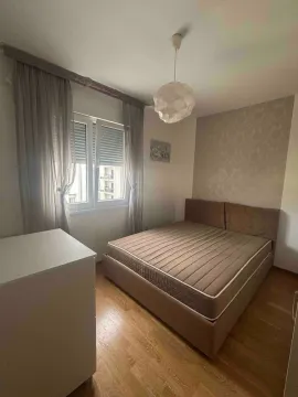 Furnished bedroom with a double bed and a window. - image 10