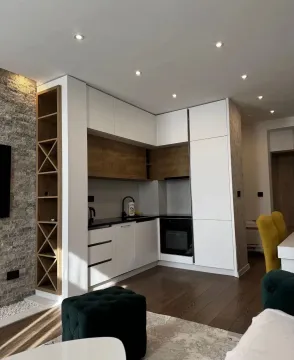 Modern kitchen with white cabinets and wooden details. - image 3