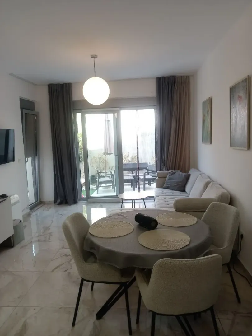 Living room with a dining area and access to the terrace.