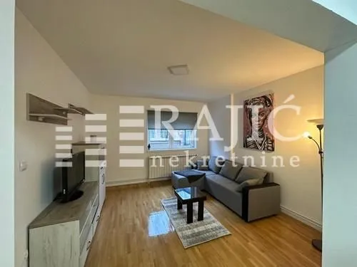 Living room with a sofa and TV cabinet.