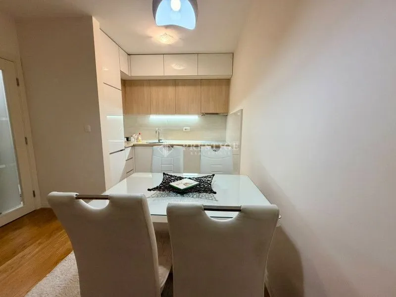 Modern kitchen with dining area and white cabinetry.