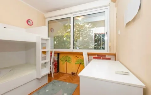 Children's bedroom with a bunk bed and a desk. - image 4