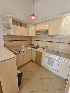 Kitchen equipped with light-toned cabinetry and built-in appliances. - image 3