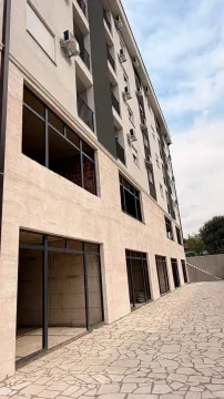 Exterior of a modern residential building with a paved courtyard. - image 3