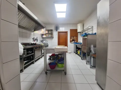 Commercial kitchen with professional equipment and stainless steel work surfaces. - image 6