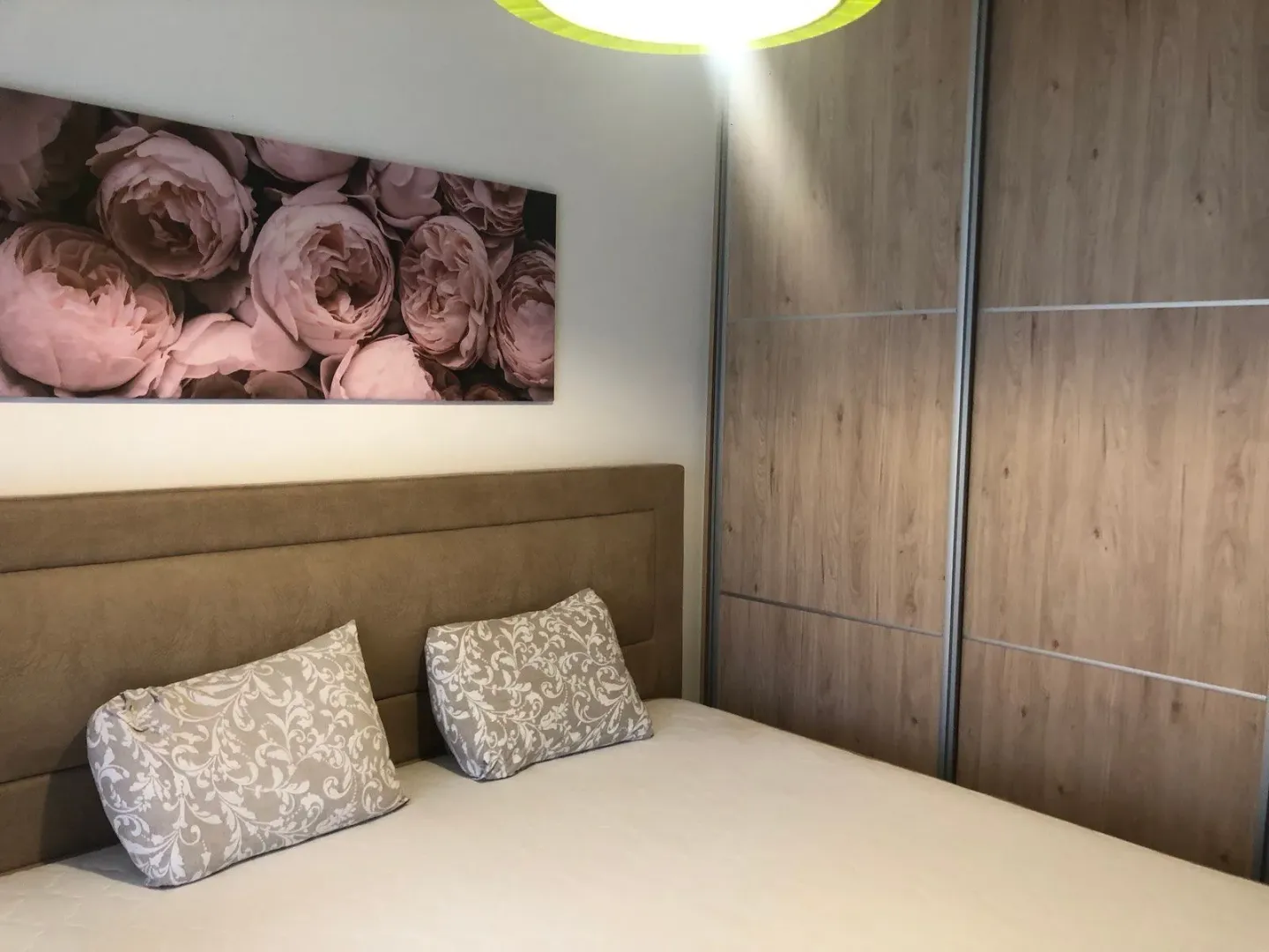 Bedroom with a double bed, headboard, and built-in wardrobe.