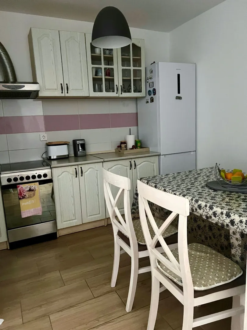 Kitchen with a dining table and kitchen appliances.