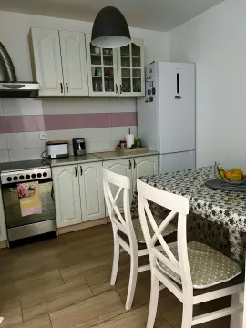 Kitchen with a dining table and kitchen appliances. - image 2