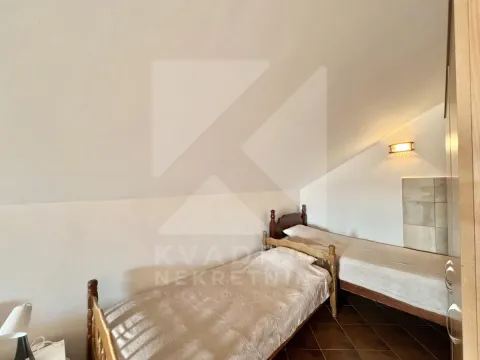 Attic bedroom furnished with two wooden beds. - image 8