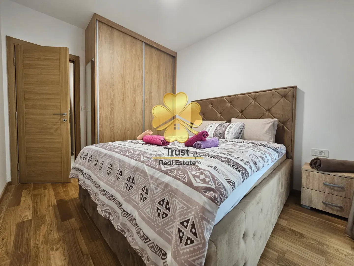 Furnished bedroom with a double bed and built-in wardrobe.