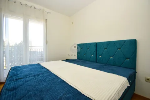 Bedroom with a double bed and balcony doors. - image 7