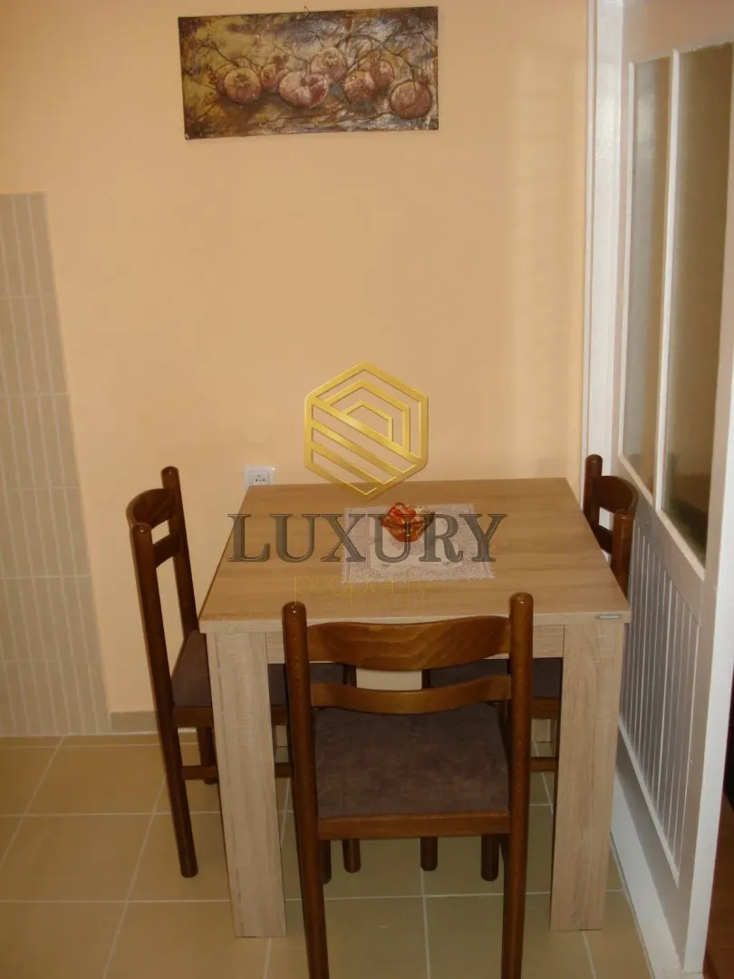 Small dining area with a wooden table and four chairs.