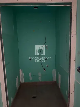 A view of a room under construction lined with green plasterboard. - image 8
