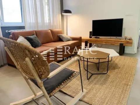 Modern living room with a sofa and TV. - image 2