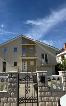 Front view of a two-story house with a yard gate and balcony. - image 14