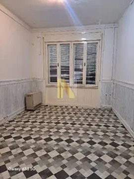 Empty room with a window and tiled floor. - image 2
