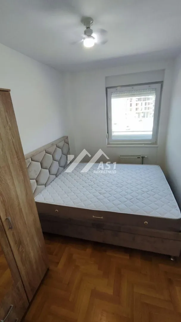 Bedroom with a double bed, wardrobe, and a window.