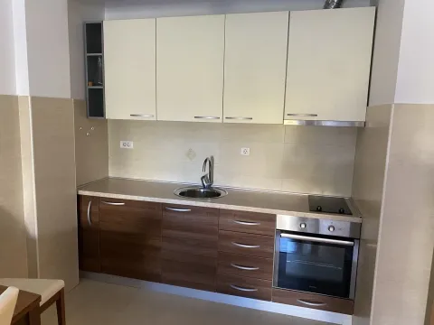 Simple kitchen with built-in appliances and a sink. - image 3