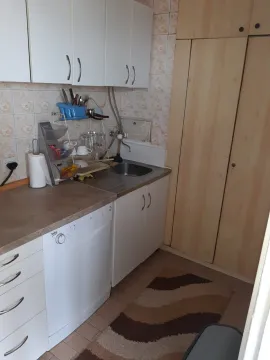 Simple kitchen with white cabinets and a dishwasher. - image 4