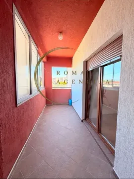 Enclosed balcony with tiled floor and red ceiling. - image 4