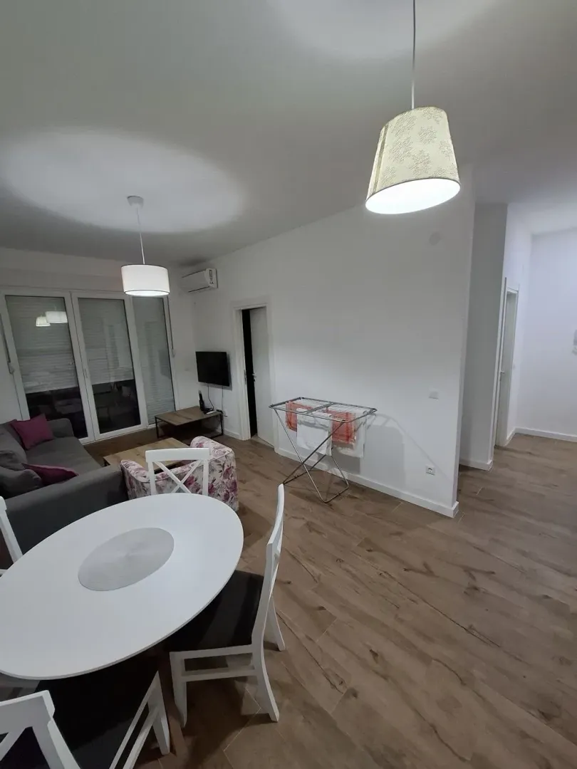 Living room with dining area and bright walls.
