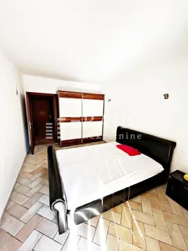 Bedroom with a double bed, wardrobe, and tiled floor. - image 15