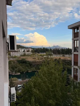 View from the terrace overlooking the city, river, and landscape. - image 10
