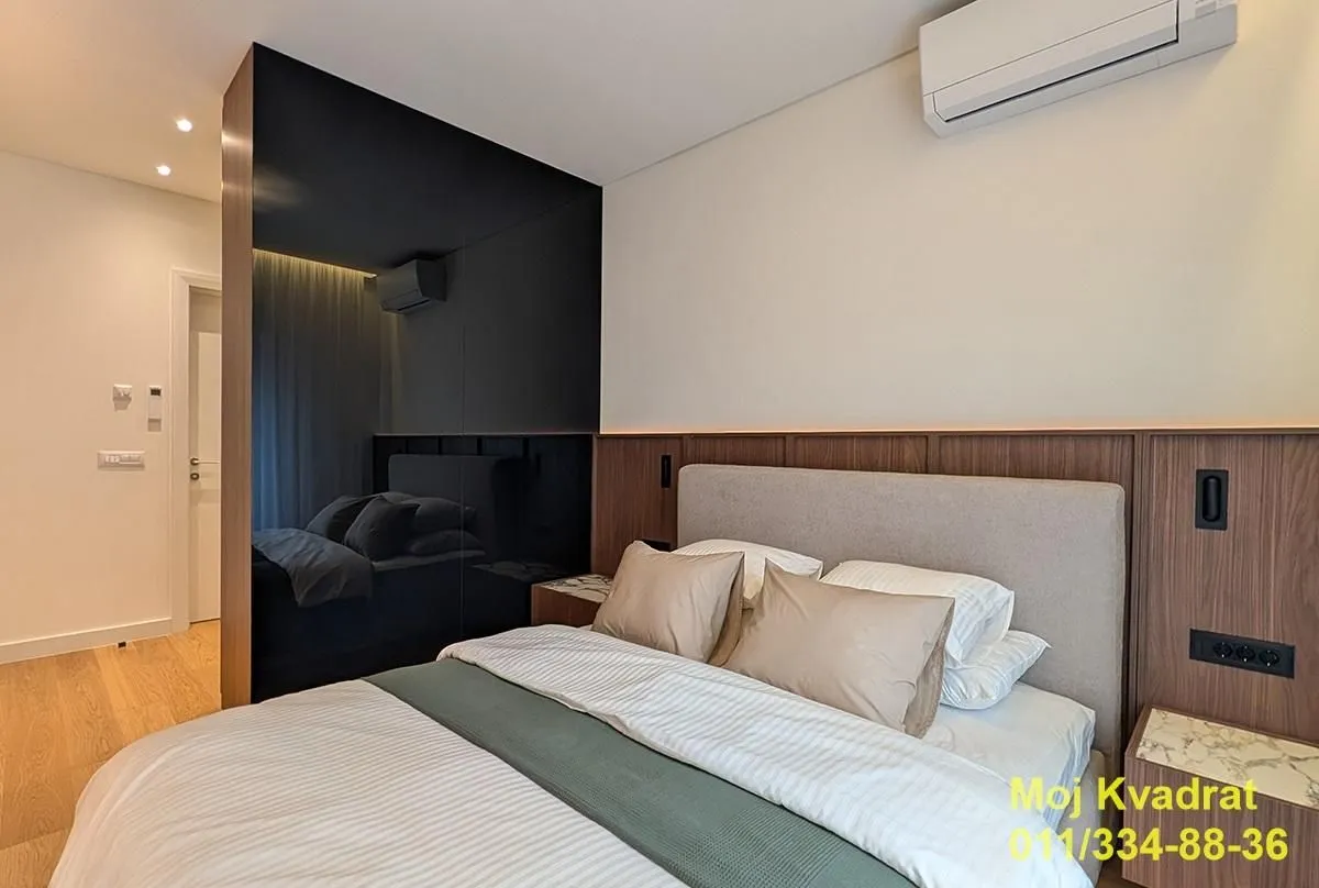 Modern bedroom with a double bed and built-in wardrobe.