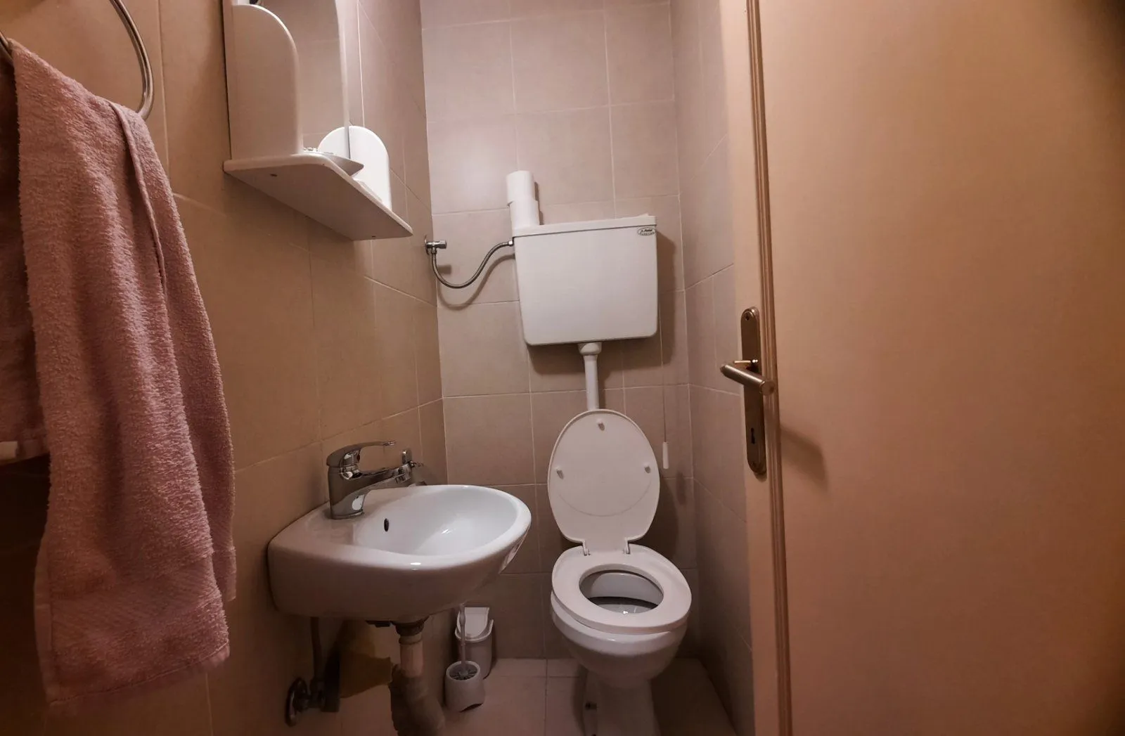 A small bathroom featuring a sink and a toilet.