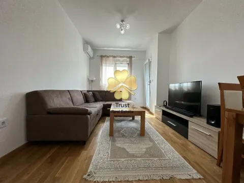 Living room with a sectional sofa, coffee table, and TV. - image 10