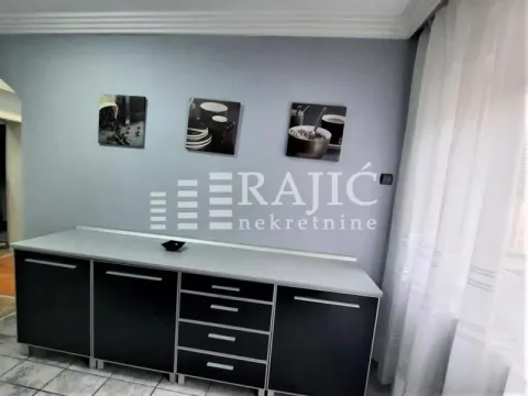 Dining area with black cabinets and wall art. - image 3