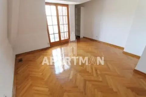 Empty room with hardwood parquet flooring and balcony doors. - image 7