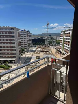 View from the terrace overlooking a construction site and surrounding buildings. - image 9