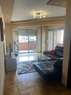 Living room with a sofa set, parquet flooring, and access to the terrace. - image 10