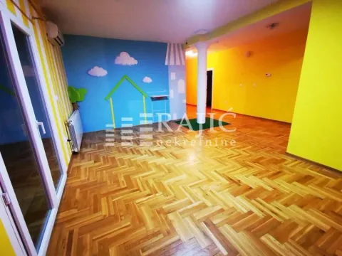 Spacious living room with parquet flooring and a decorative wall with a castle motif. - image 7