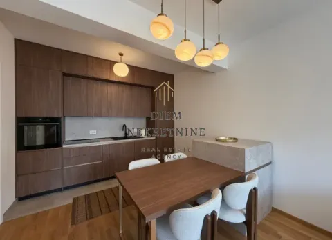 Modern kitchen with dining area and built-in appliances. - image 3