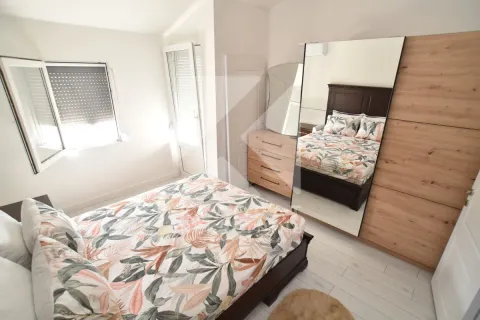 Furnished bedroom with a double bed, wardrobe, and large mirror. - image 22