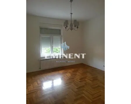 Empty room with parquet flooring and a chandelier on the ceiling. - image 5