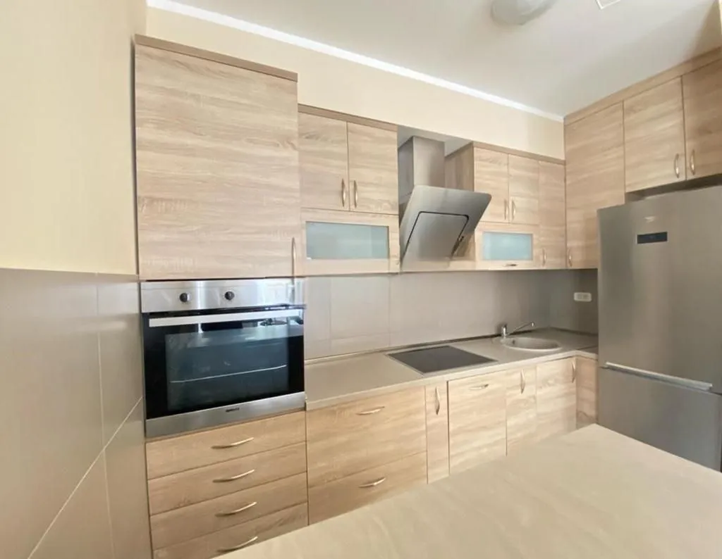 Kitchen equipped with wooden cabinets and built-in appliances.