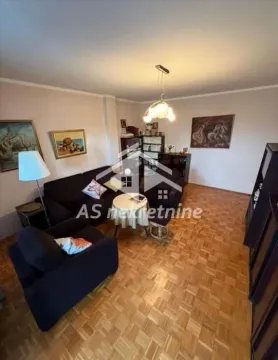 Living room with a sofa set, coffee table, and wooden flooring. - image 6