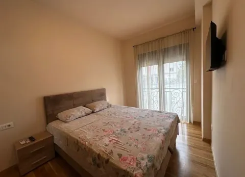 Furnished bedroom with a double bed and access to a balcony. - image 6