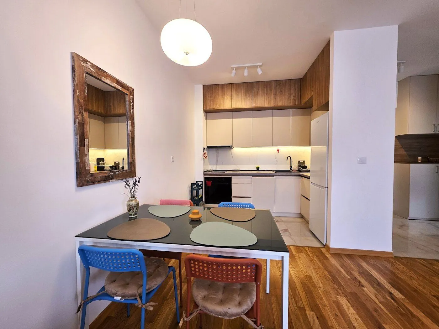 Modern kitchen with a dining area and built-in appliances.